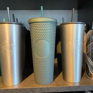 Navy green studded 24 oz cup with siren logo in front